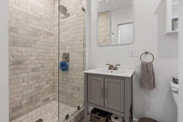 bathroom featuring a tile shower and vanity