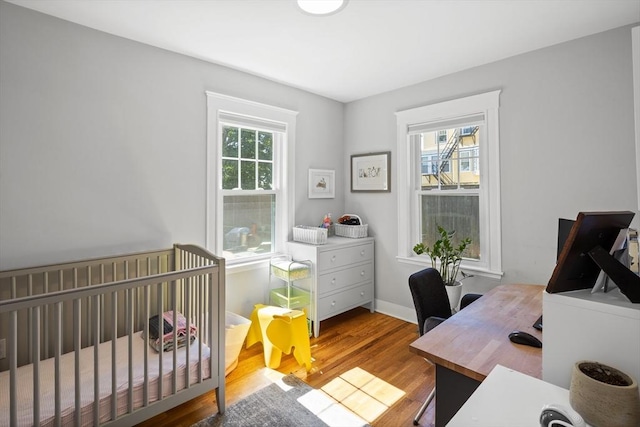 bedroom featuring baseboards and wood finished floors