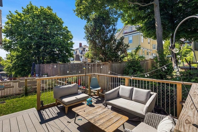 deck featuring outdoor lounge area and fence