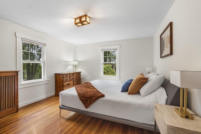 50 Grove Hill Park, Newton, MA 02460 - bedroom with baseboards, multiple windows, and wood finished floors