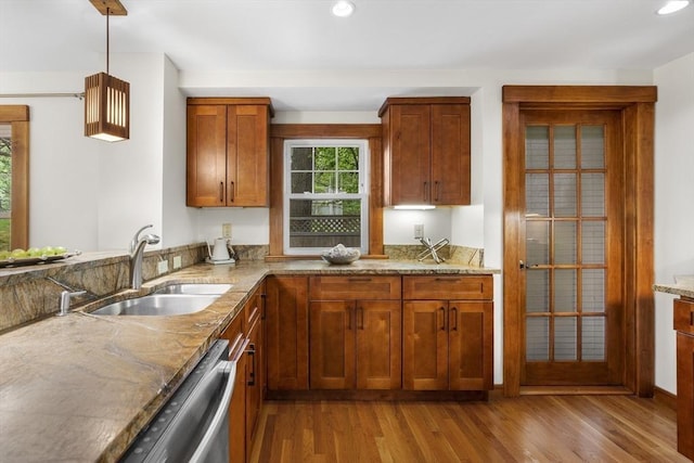 50 Grove Hill Park, Newton, MA 02460 - kitchen with brown cabinets, light stone counters, a sink, wood finished floors, and stainless steel dishwasher