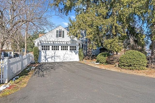 garage with driveway and fence