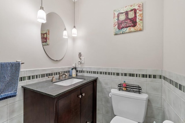 38 Concord Sq Unit 2, Boston, MA 02118 - half bath featuring tile walls, vanity, and a wainscoted wall