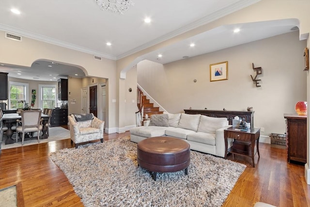 38 Concord Sq Unit 2, Boston, MA 02118 - living room featuring arched walkways, wood finished floors, ornamental molding, stairs, and recessed lighting