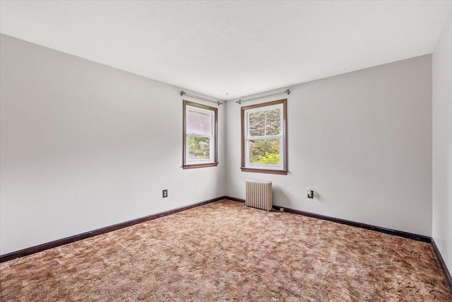 61 Mattawa Cir, Orange, MA 01364 - empty room featuring radiator heating unit and carpet flooring
