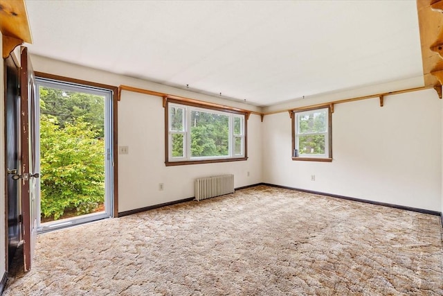 61 Mattawa Cir, Orange, MA 01364 - empty room featuring radiator, carpet, and plenty of natural light