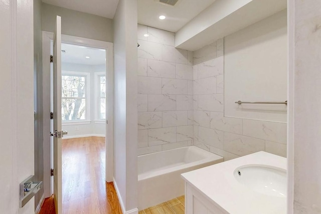 full bathroom featuring vanity, bathtub / shower combination, and wood finished floors