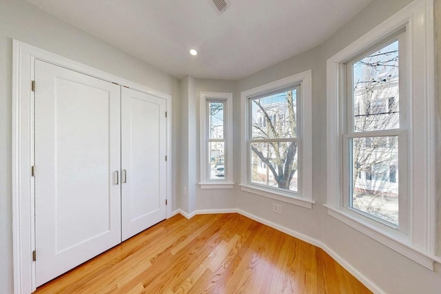 unfurnished bedroom featuring recessed lighting, visible vents, baseboards, and light wood finished floors