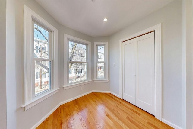 unfurnished bedroom with light wood-style flooring, recessed lighting, and baseboards