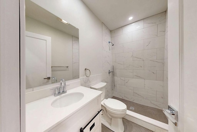 bathroom with vanity, a shower stall, toilet, and recessed lighting