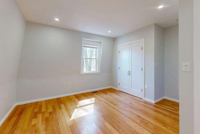 unfurnished bedroom with recessed lighting, baseboards, and light wood-style floors