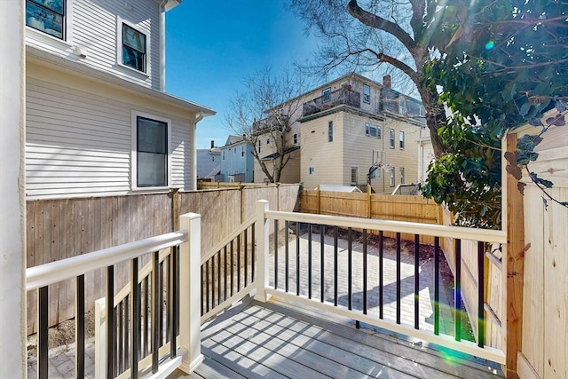 deck featuring fence and a residential view