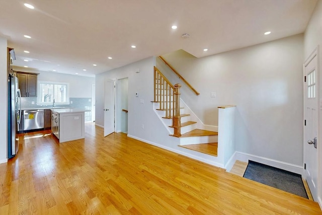 entrance foyer featuring stairway, recessed lighting, light wood-type flooring, and baseboards