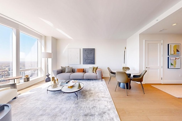 living room with baseboards and light wood-type flooring