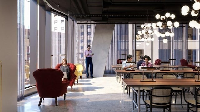 dining space featuring concrete flooring, a notable chandelier, a wall of windows, and a wealth of natural light