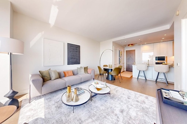 living area with recessed lighting, baseboards, and wood finished floors