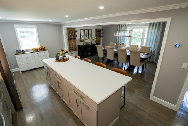 796 Foundry St, Easton, MA 02375 - kitchen with crown molding, a center island, dark wood-style floors, light countertops, and recessed lighting