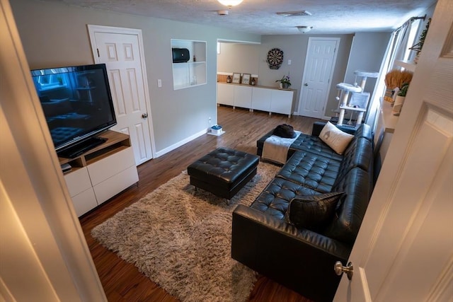 796 Foundry St, Easton, MA 02375 - living area featuring wood finished floors, built in shelves, and a textured ceiling