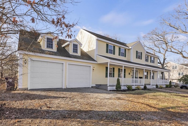 view of front of property featuring a porch and a garage