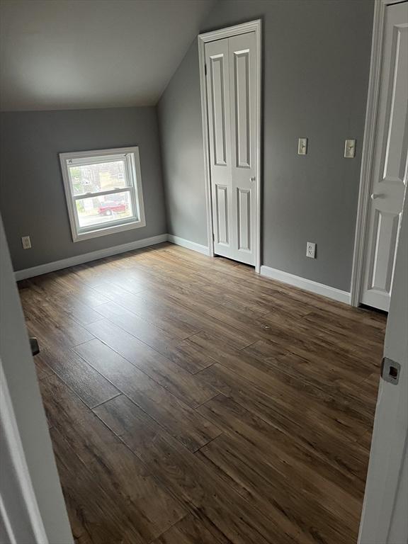 422 County St, Fall River, MA 02723 - unfurnished bedroom with wood finished floors, lofted ceiling, and baseboards