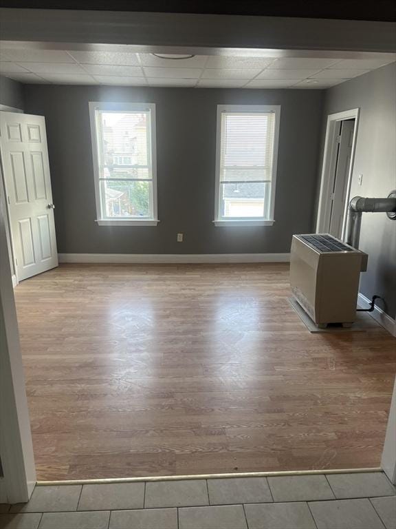 422 County St, Fall River, MA 02723 - unfurnished bedroom featuring a drop ceiling, baseboards, and wood finished floors