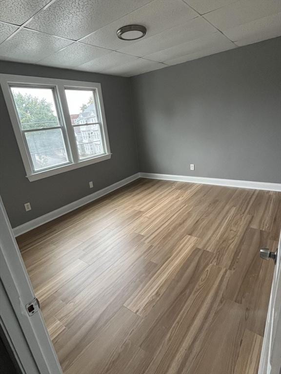 422 County St, Fall River, MA 02723 - empty room with wood finished floors, a drop ceiling, and baseboards
