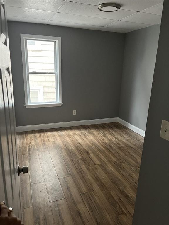 422 County St, Fall River, MA 02723 - empty room with wood finished floors, baseboards, and a paneled ceiling