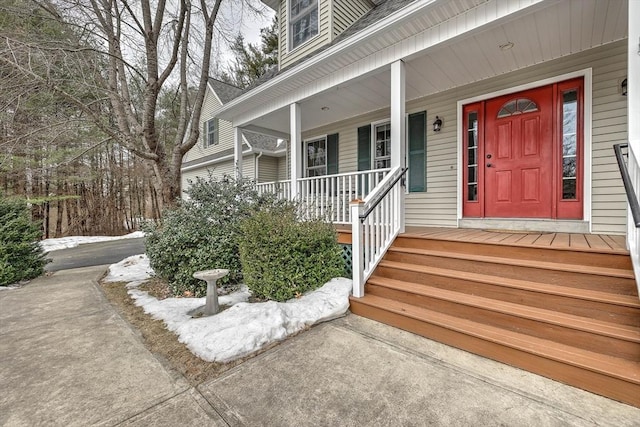 property entrance with a porch and a shingled roof