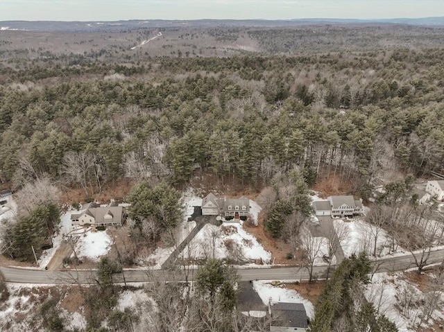 drone / aerial view with a wooded view