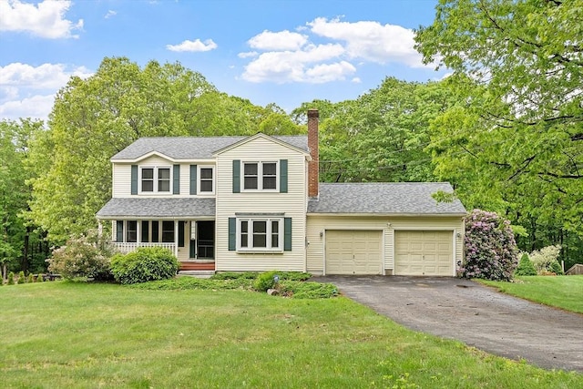 71 Johnny Appleseed Ln, Leominster, MA 01453 - traditional-style house with an attached garage, driveway, covered porch, a front yard, and a chimney