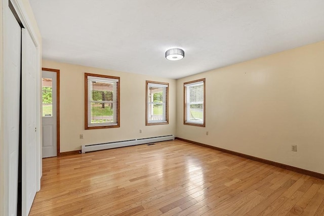 71 Johnny Appleseed Ln, Leominster, MA 01453 - empty room featuring a baseboard radiator, plenty of natural light, and light wood-style flooring