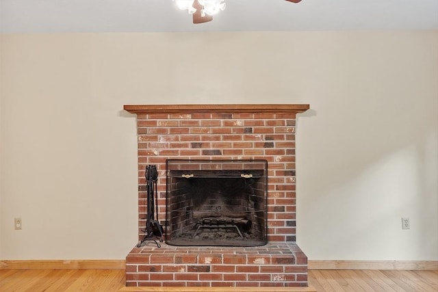 71 Johnny Appleseed Ln, Leominster, MA 01453 - detailed view of baseboards, wood finished floors, ceiling fan, and a brick fireplace