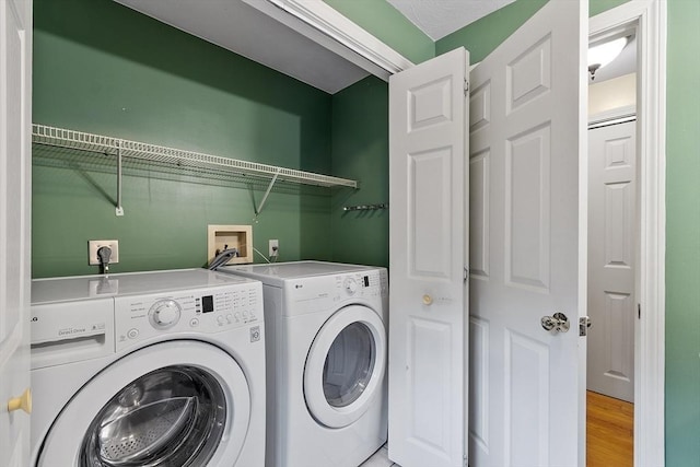 71 Johnny Appleseed Ln, Leominster, MA 01453 - washroom with washing machine and clothes dryer and light wood-style floors