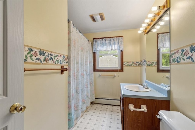 71 Johnny Appleseed Ln, Leominster, MA 01453 - full bathroom featuring baseboard heating, toilet, tile patterned floors, vanity, and a wainscoted wall