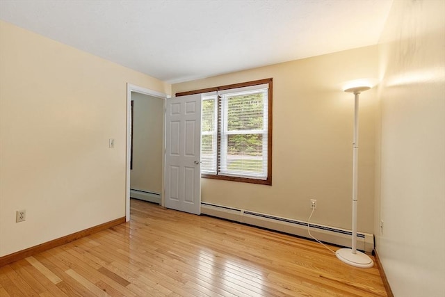 71 Johnny Appleseed Ln, Leominster, MA 01453 - spare room featuring baseboard heating, light wood finished floors, and baseboards