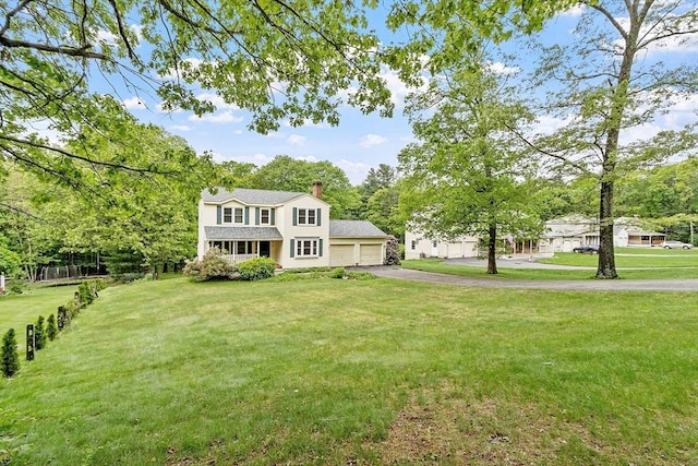 71 Johnny Appleseed Ln, Leominster, MA 01453 - view of front of home featuring driveway, an attached garage, a front yard, and a chimney