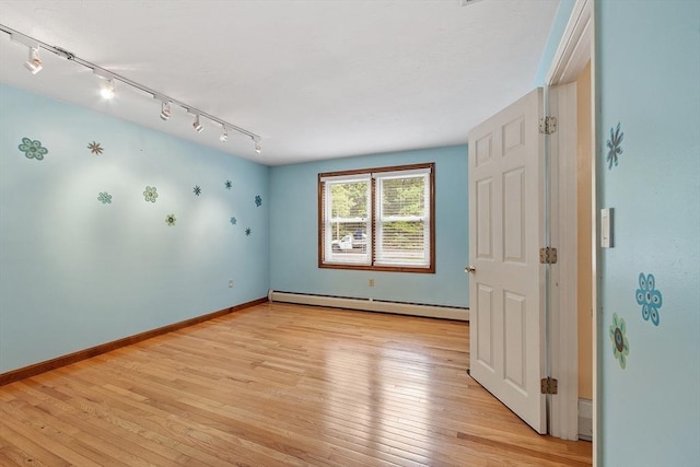71 Johnny Appleseed Ln, Leominster, MA 01453 - unfurnished room with baseboard heating, track lighting, light wood finished floors, and baseboards