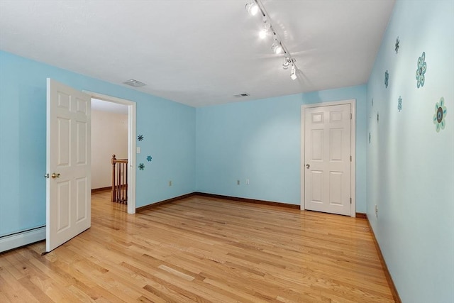71 Johnny Appleseed Ln, Leominster, MA 01453 - spare room featuring light wood finished floors, baseboards, and track lighting