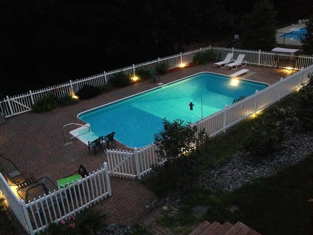 71 Johnny Appleseed Ln, Leominster, MA 01453 - pool at twilight featuring a fenced backyard, a patio area, and a diving board