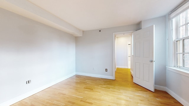 spare room featuring a wealth of natural light and light wood-type flooring