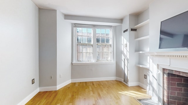 unfurnished living room featuring light hardwood / wood-style floors