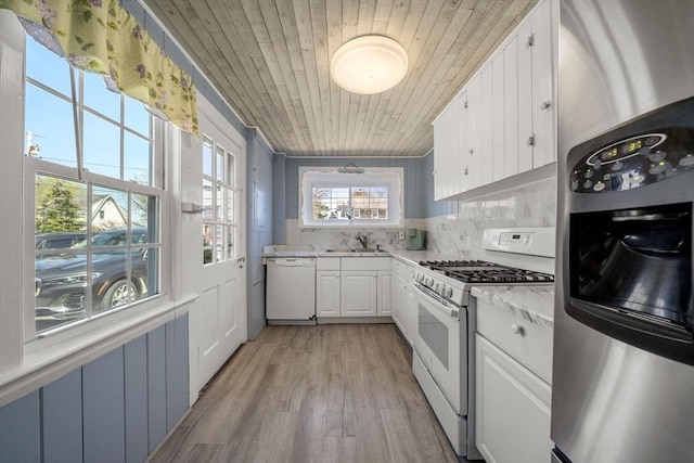 kitchen featuring white appliances, a sink, wooden ceiling, white cabinetry, and decorative backsplash
