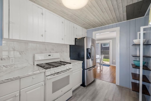 kitchen with white range with gas cooktop, stainless steel fridge, wooden ceiling, light wood-type flooring, and white cabinetry