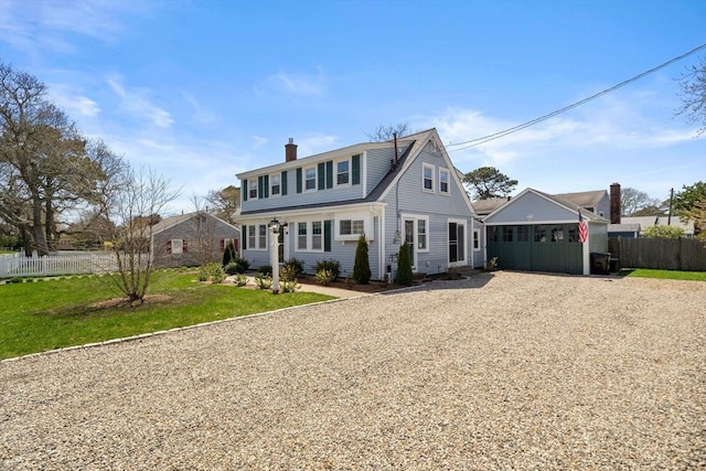 view of front of house featuring gravel driveway and a chimney