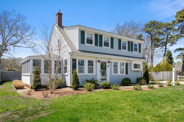 view of front of house featuring a chimney and a shingled roof