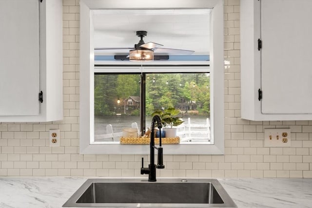 11 Hamilton Dr, Holland, MA 01521 - kitchen view of a sink, decorative backsplash, white cabinetry, and light stone countertops