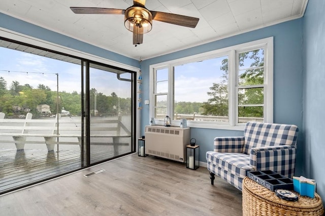11 Hamilton Dr, Holland, MA 01521 - sitting room with radiator heating unit, ceiling fan, wood finished floors, and ornamental molding