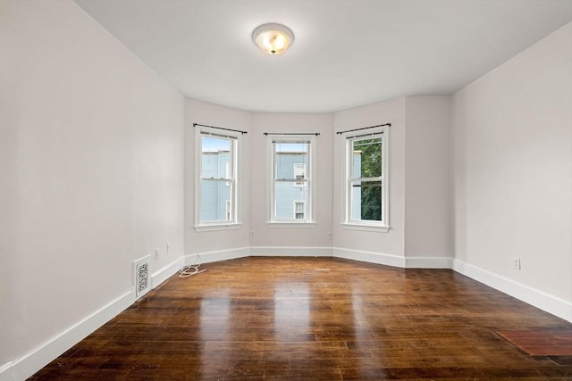 spare room featuring dark hardwood / wood-style flooring