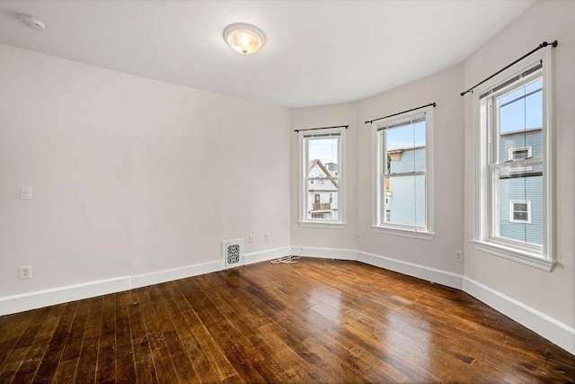 spare room featuring wood-type flooring