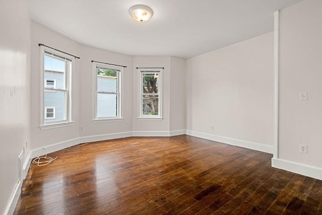 spare room with dark wood-type flooring